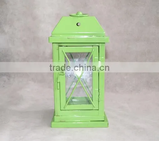 green metal lantern with clear glass wall