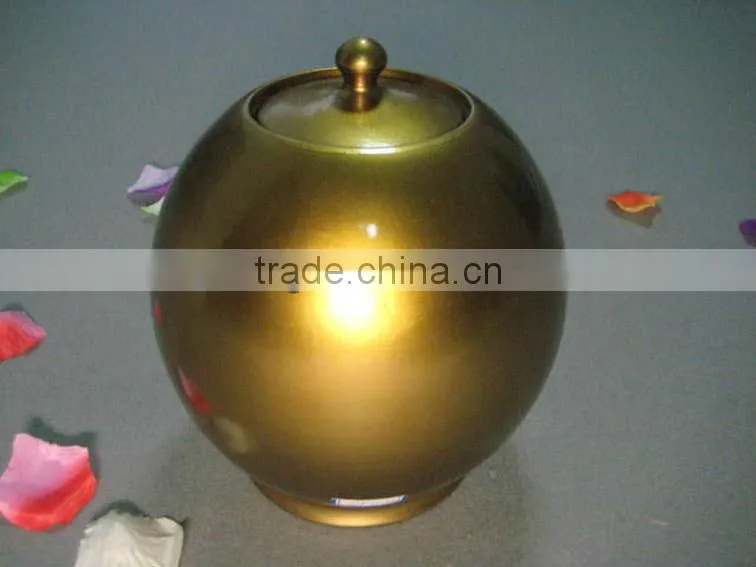 Golden ceramic urns for ashes