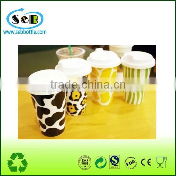 white ceramic cup with lid and silicone sleeve