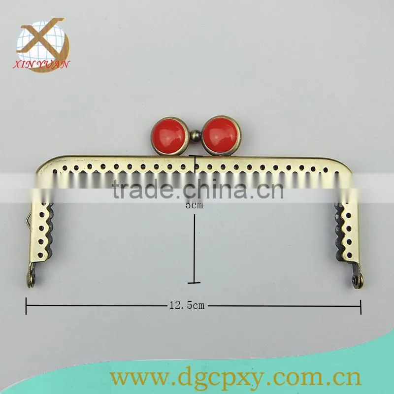 small metal purse frame with whirte gems