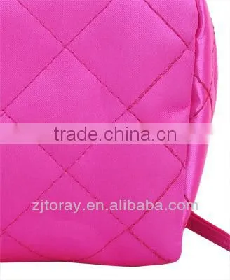 Lightweight quilted cosmetic bag featuring a zippered placket along the top and sides