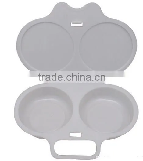 A HANDY TWIN EGG POACHER W/HINGED LID IN MICROWAVE OVEN