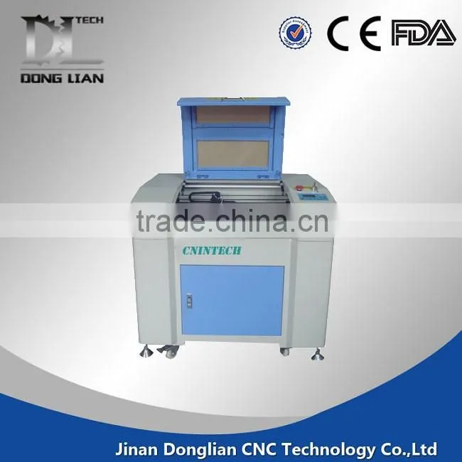 6040 small model alibaba hot sale jinan donglian used co2 laser cutting machine for pvc/glass