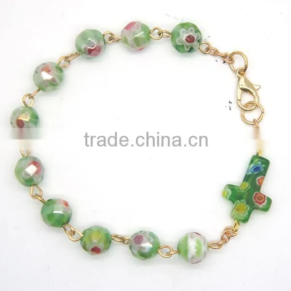 Colorful faceted beads and cross connected by lobster clasp