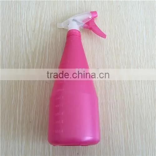 pink plastic garden spray bottle with trigger