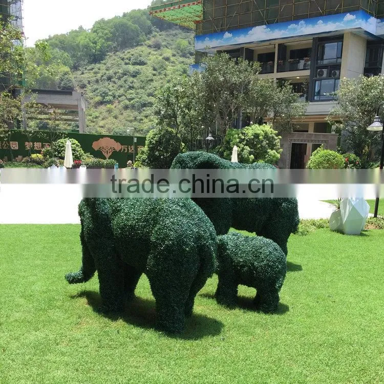 Green grass elephant statue