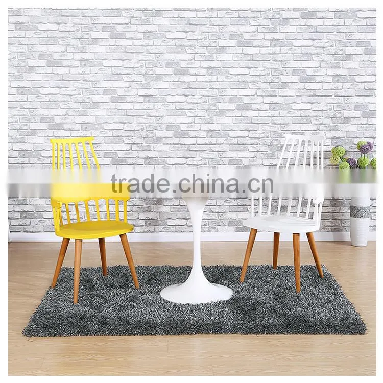 White plastic chair with beechwood legs