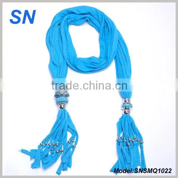 Women adorn article scarf with jewelry