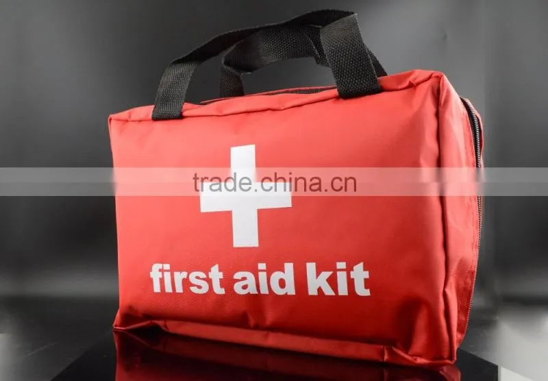 Emergency first aid travel kit in red cross bag for outdoor treatment