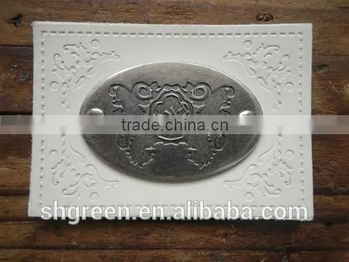 Embossed leather patch with metal logo for lady's handbag
