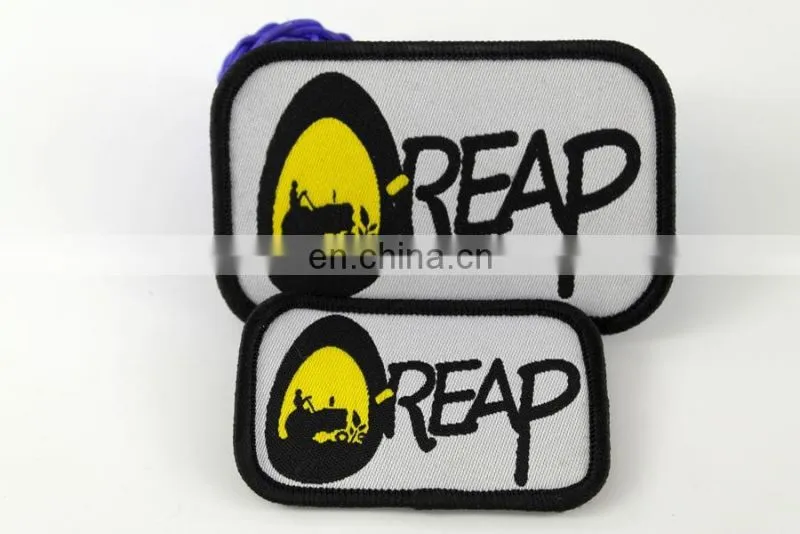 die cut shape with logo book and bird woven military emblems