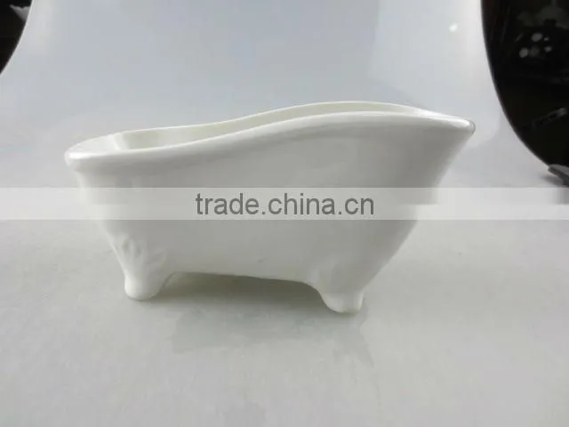 stocked white ceramic boat-shaped saucer dish