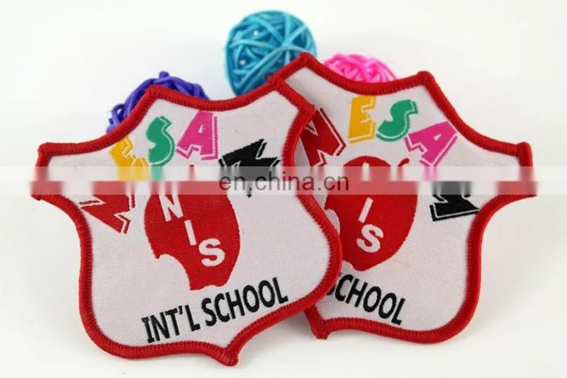 die cut shape with logo book and bird woven military emblems