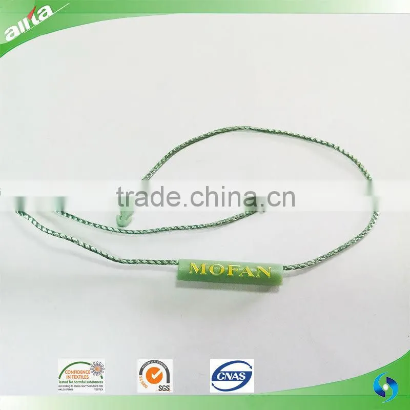 China Gold Supplier, customize gold color seal tag with letters embossed on light freshening green garment plastic hang tag