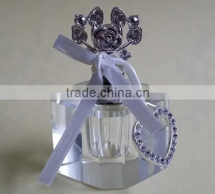 small empty clear crystal perfume bottle with jewelled metal alloy handle