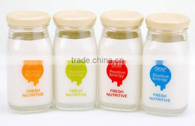 Glass baby bottle with red cap