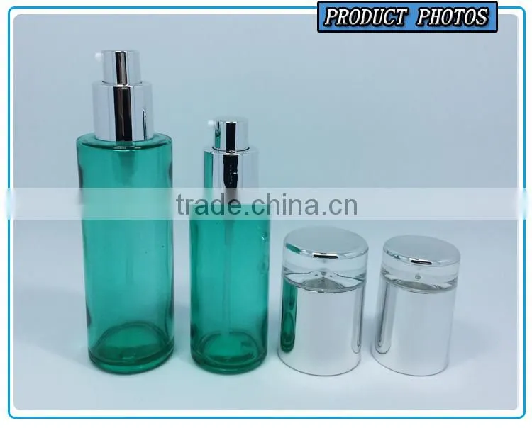 Empty green colored glass cosmetic bottle and cosmetic glass cream jar