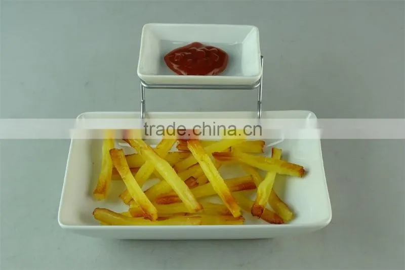 stocked white ceramic rectangle French fries serving plate with dipping dish and iron stand