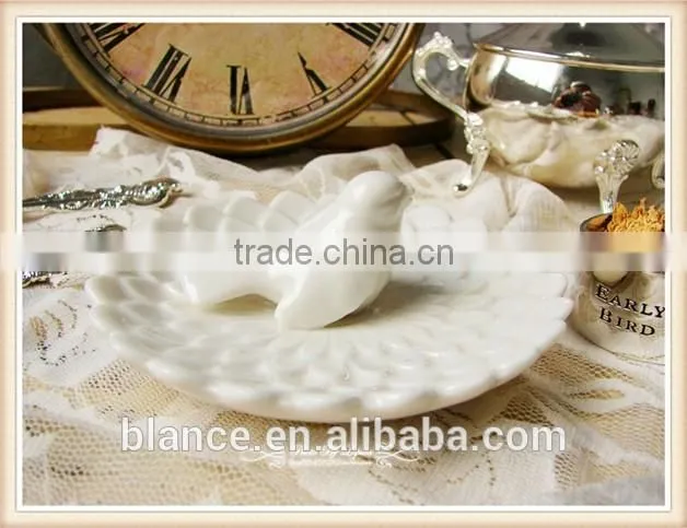 antique white porcelain plate with small bird in middle