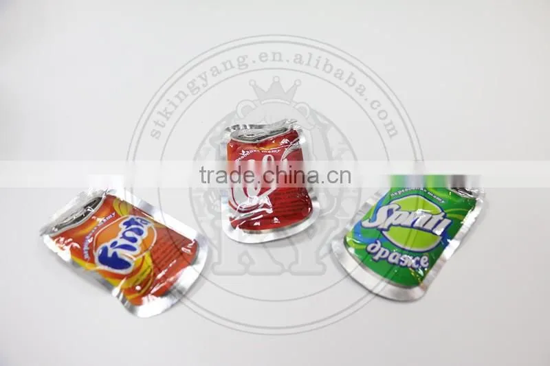 Cola bottle shaped compressed fizzy hard candy with tatoo paper