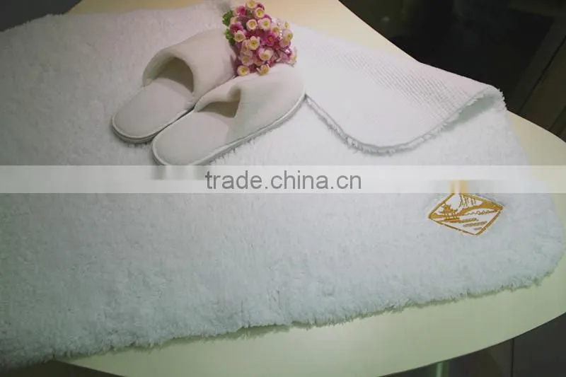 cotton bath rug hand tuffted with embroidered logo