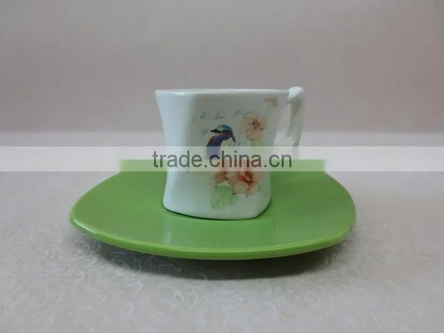 a set of small ceramic coffee cup with green saucer