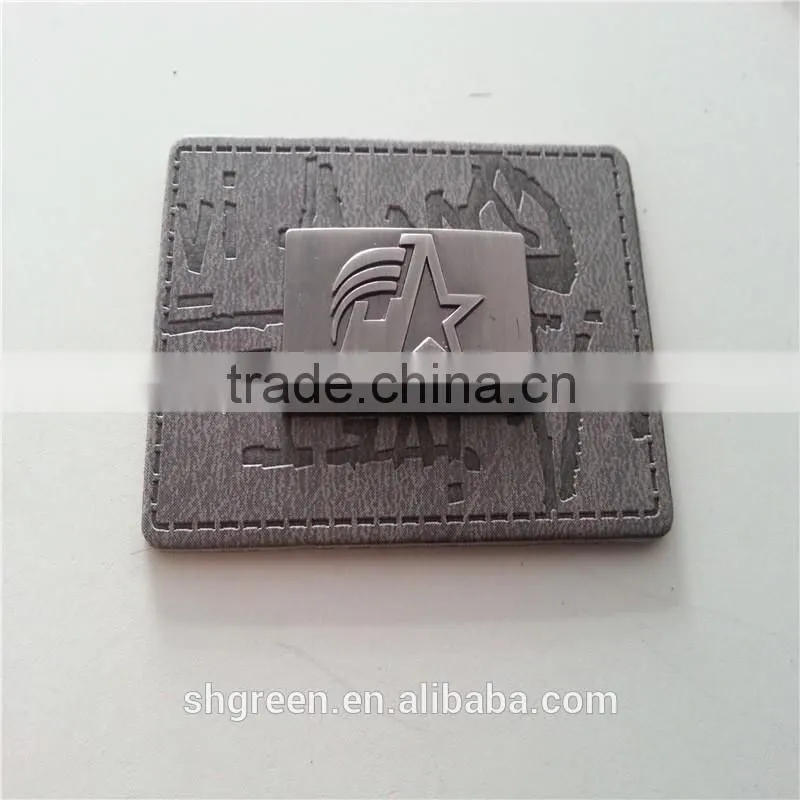Embossed leather patch with metal logo for lady's handbag