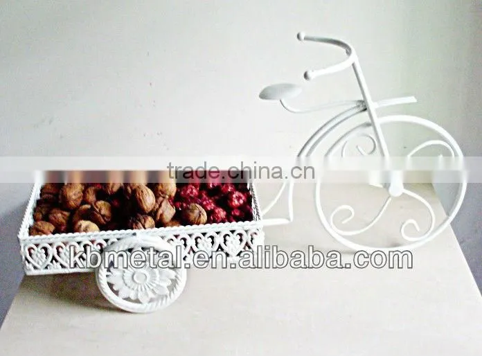 white three-wheel cart fruit plates