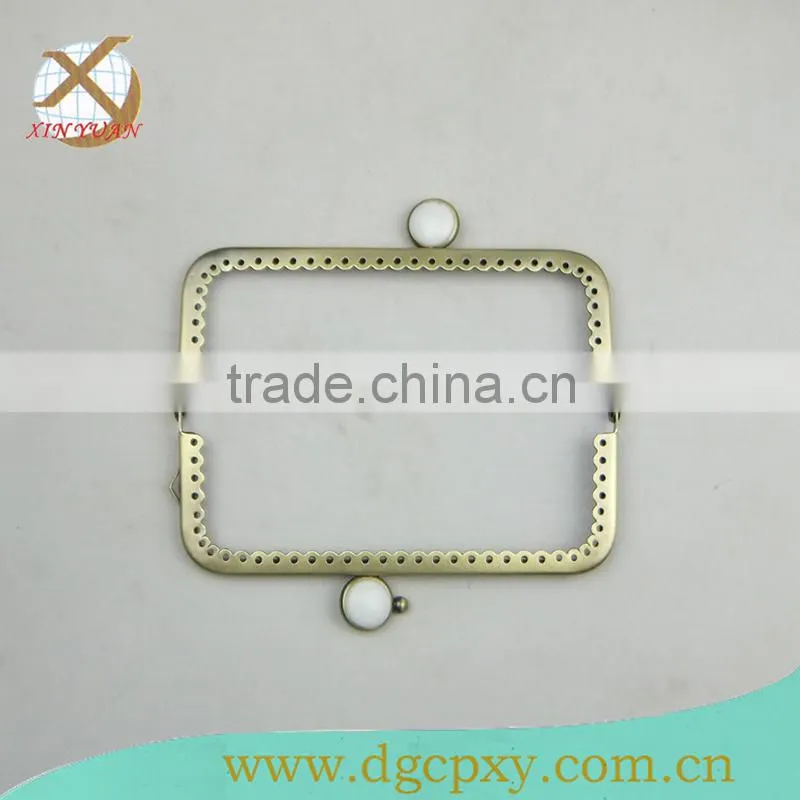 small metal purse frame with whirte gems