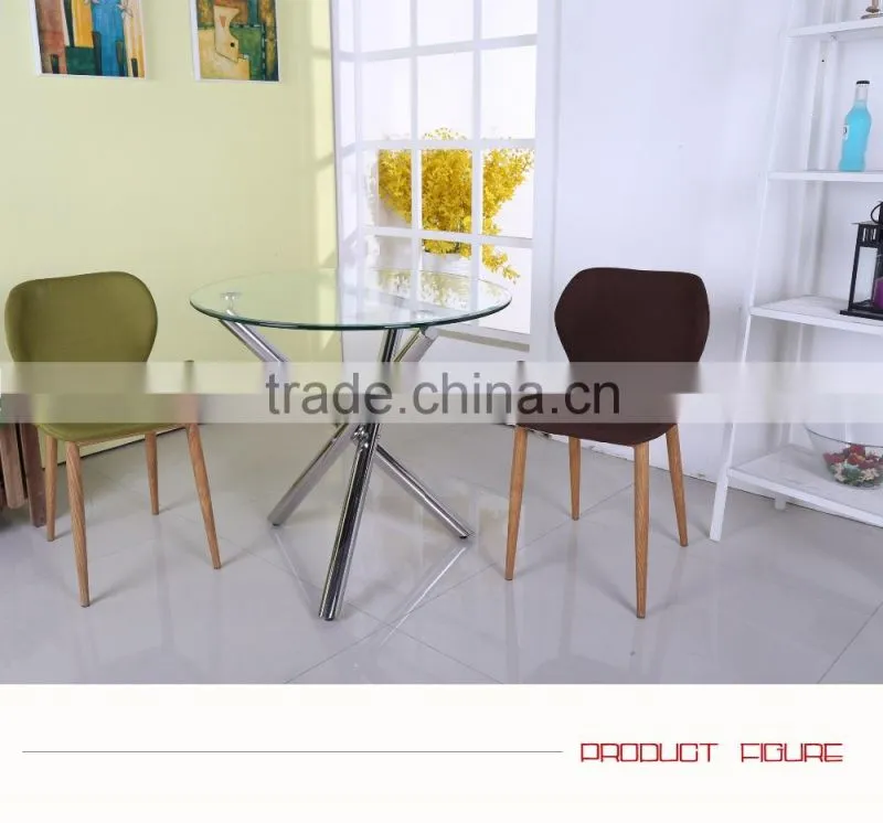Round glass dining table with 3 metal legs