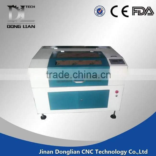 6040 small model alibaba hot sale jinan donglian used co2 laser cutting machine for pvc/glass