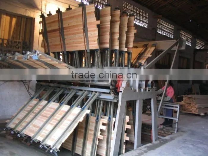 Pneumatic wood composer rotary clamp carrier for wood