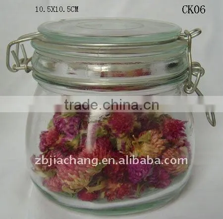 Clear glass food storage bottle with metal clip