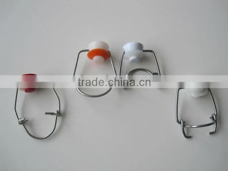 Swing cap with ceramic and plastic top with metal wire
