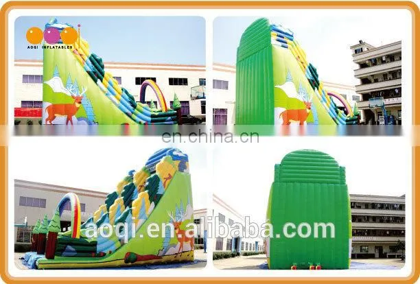 AOQI new style rainbow forest outdoor inflatable high slide with inflatable rock climbing wall for adults