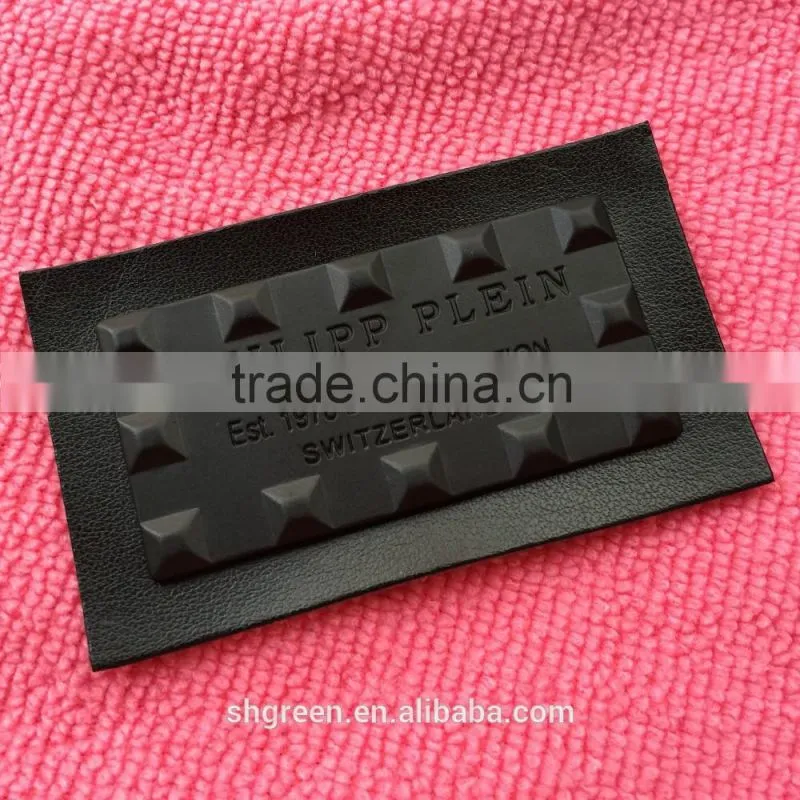 Shiny golden color metal badge on black leather
