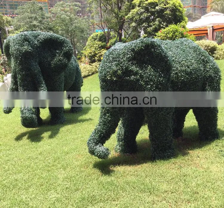 Green grass elephant statue