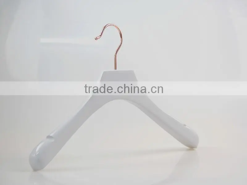 white wooden hanger and pants hanger for luxury garment