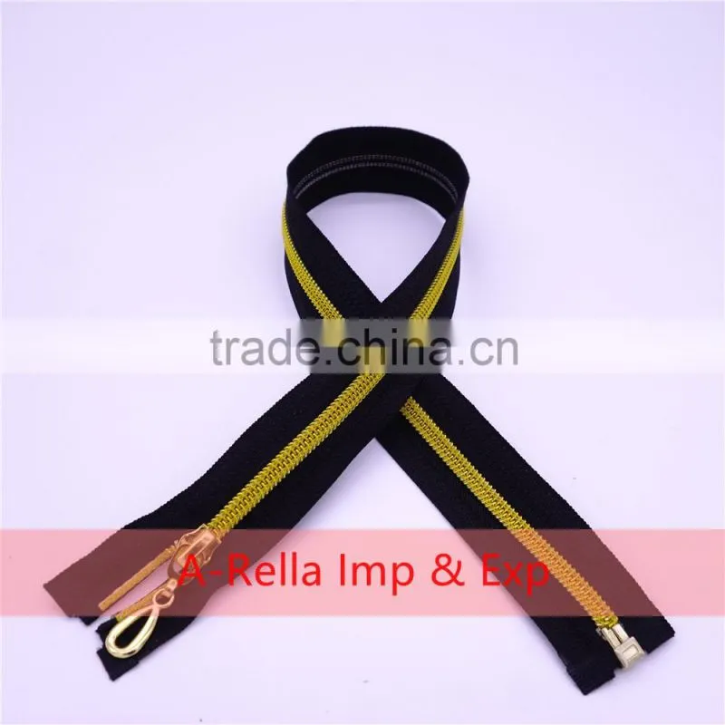 Zipper puller with golden elements