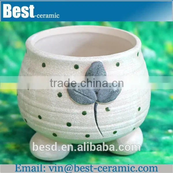 hand painting small white ceramic flower pots
