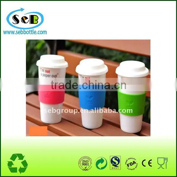 white ceramic cup with lid and silicone sleeve