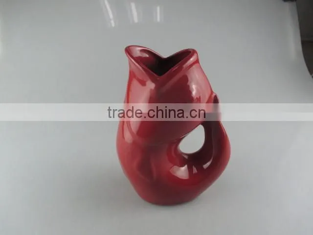 red-glazed ceramic fish vase