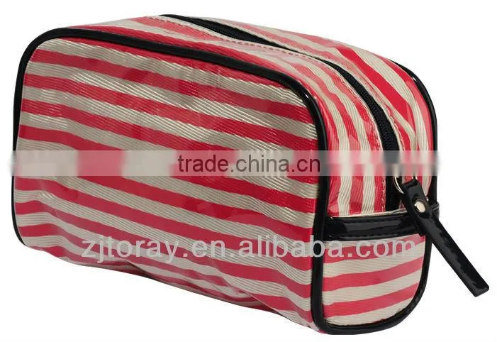 Small clear coated cosmetic bag featuring a coated stripe pattern zippered placket along the top