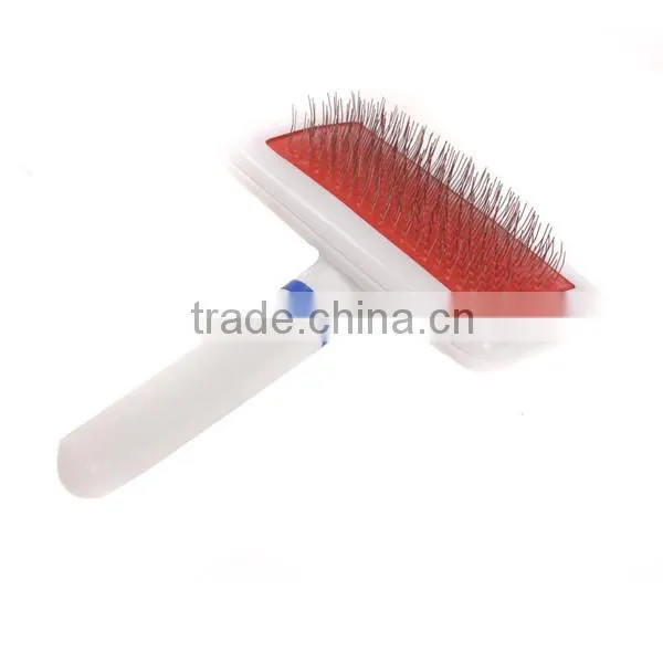 white plastic dog groom brush