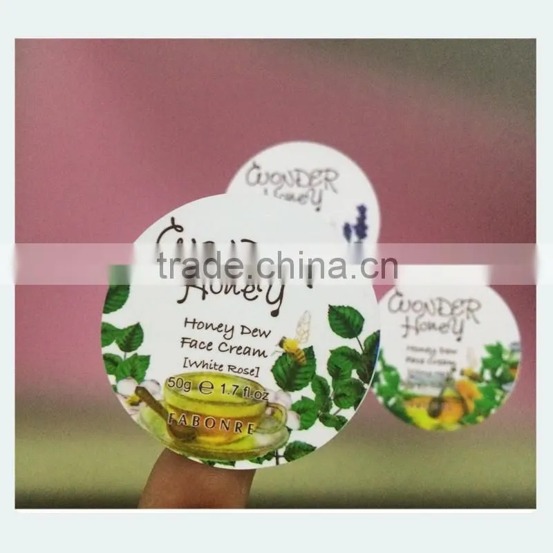 Round adhesive sticker label used in face cream bottle
