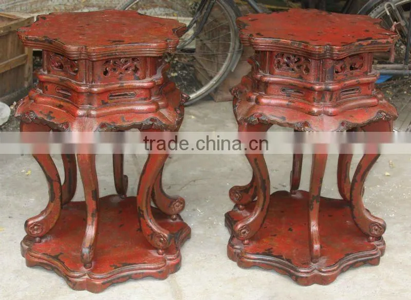 red wooden flower stool