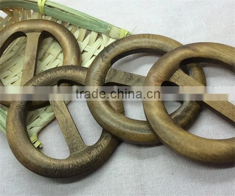Antique hand carved round wooden belt buckle