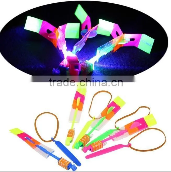Hot sellingElastic Toy Gift Flash Rotating Flying Arrow Rocket Helicopter/kids light up led rubbe band flashing led flying arrow