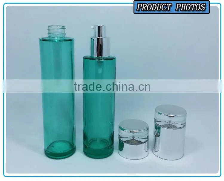 Empty green colored glass cosmetic bottle and cosmetic glass cream jar