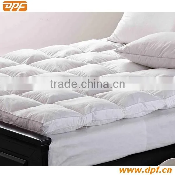 Hotel mattress pad with hollow fiber filling